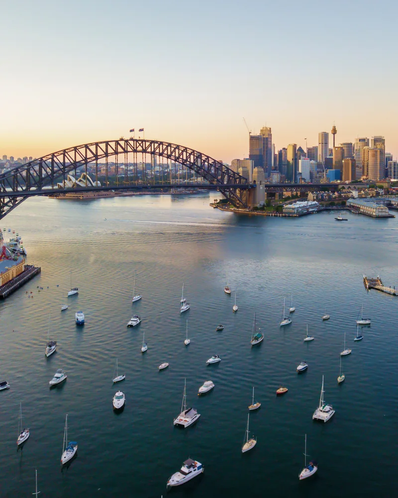 People relaxing on Observatory Hill overlooking the Sydney Harbour Bridge
